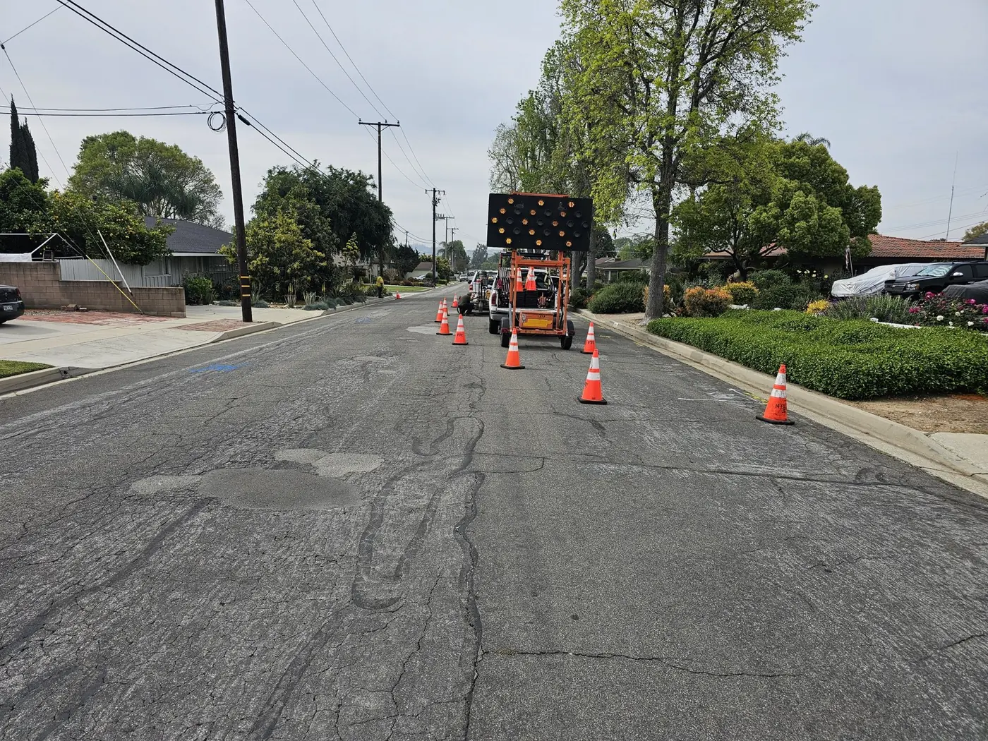 Roadway exploration setup with work vehicles and traffic cones on the Whittier pavement rehabilitation project